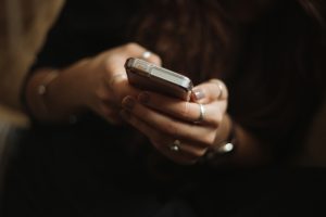 reading a message on her phone, cheap messages